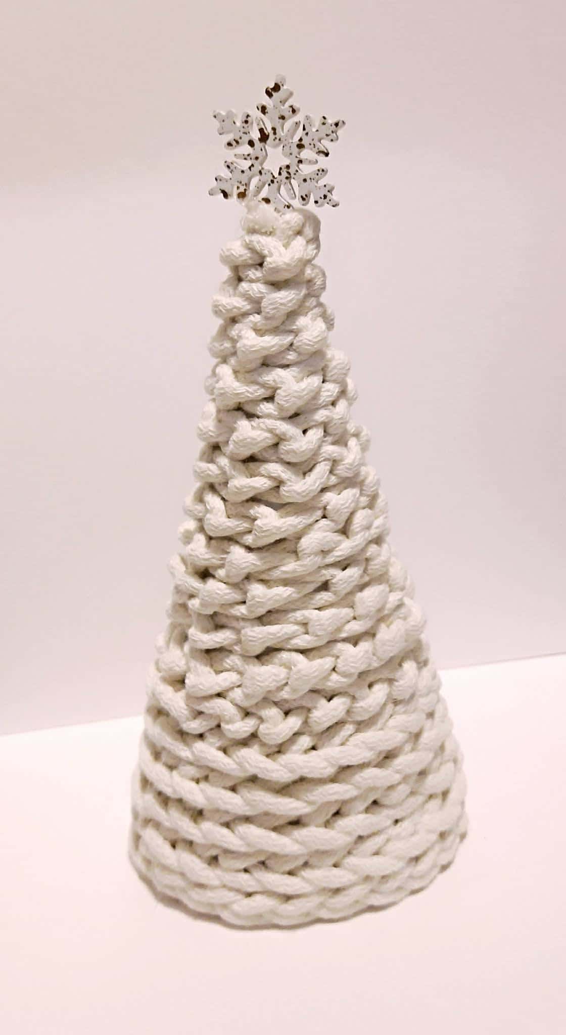 Choinka z białego sznurka w kształcie stożka z ozdobną śnieżynką na czubku – ręczna praca dziecka.
